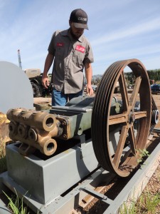 A refurbished 3364 Gaso-brand disposal well pump sits on a skid in the yard at Recovery Equipment in Abilene, ready to go back in the field. Touching the cast iron with a caring hand is Chad Keesee, operations manager. Partially visible to the left is the shield for the belt assembly. PHOTO BY HANABA MUNN WELCH