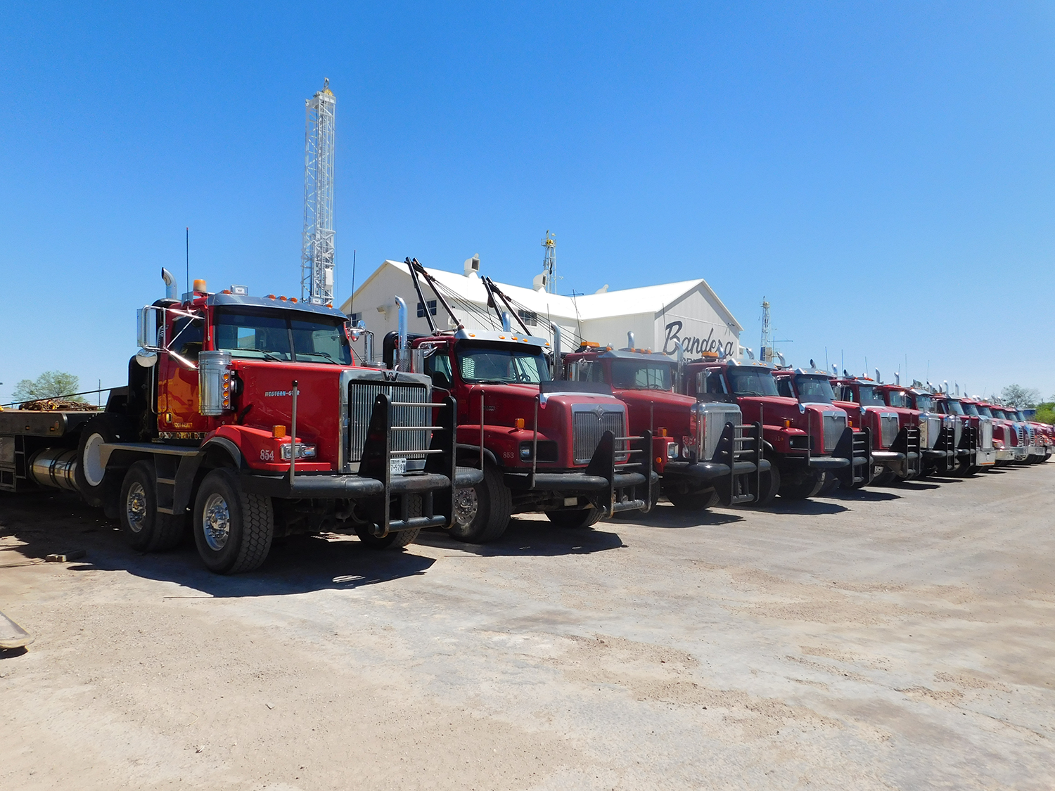 Flatbed trucks like these can haul many kinds of equipment, which makes them easier to auction outside of the the oil industry when times are hard.